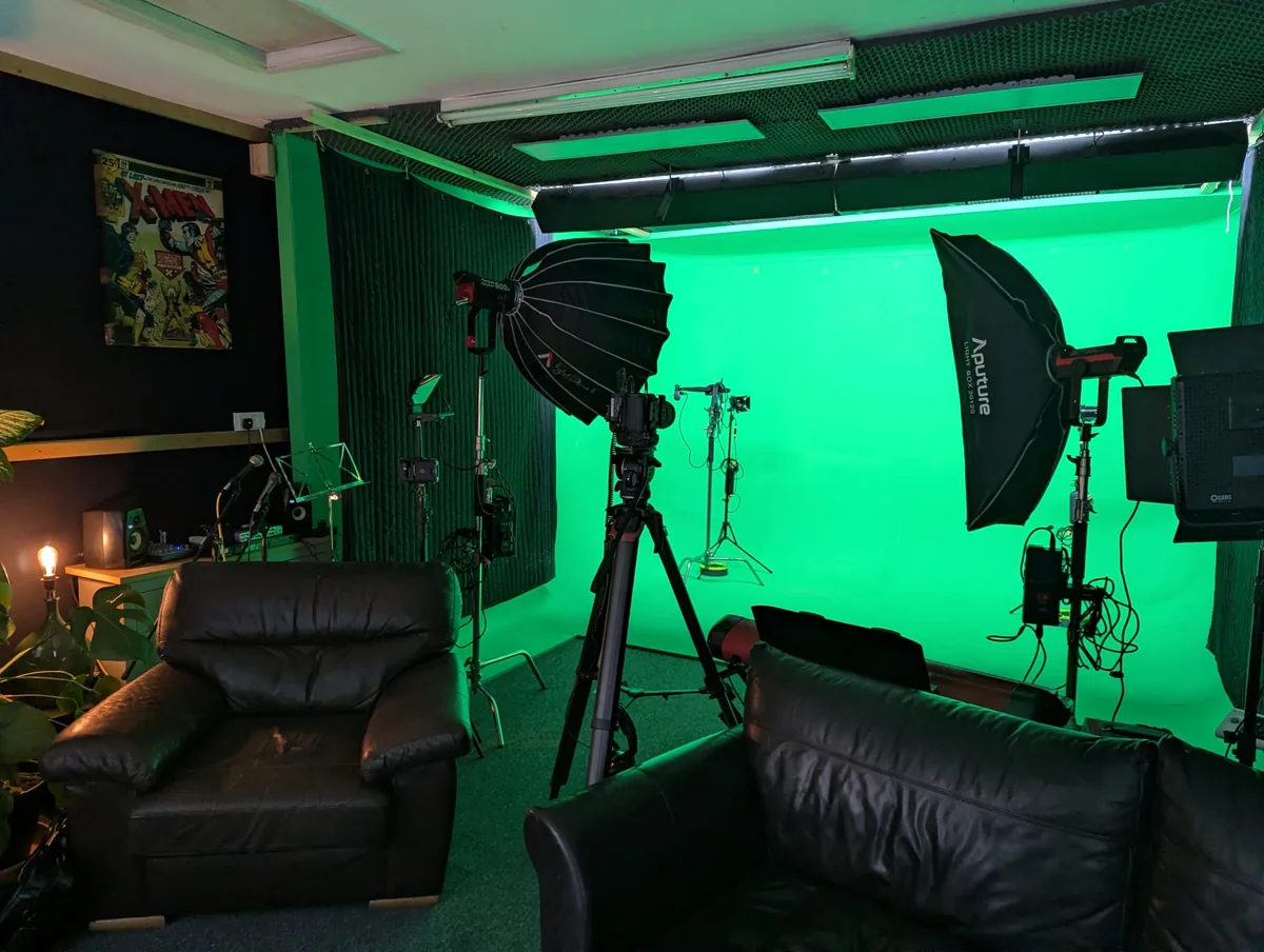 Green screen studio set up with lighting and camera equipment for filming